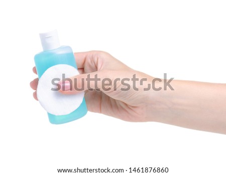 Bottle acetone nail polish remover and cotton pad in hand on white background isolation