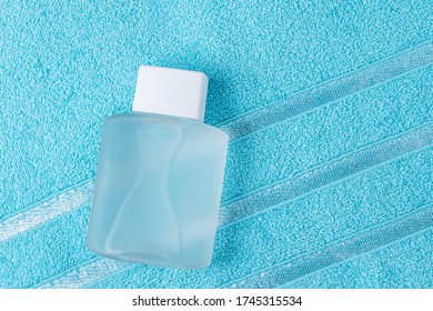 Bottle Of Aftershave Lotion On A Blue Towel