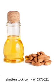 Bottle of almond oil and almonds isolated on white background