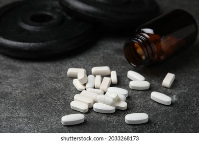 Bottle And Amino Acid Pills On Grey Table