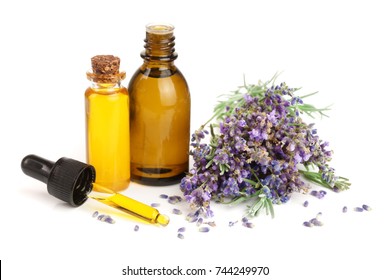 Bottle With Aroma Oil And Lavender Flowers Isolated On White Background