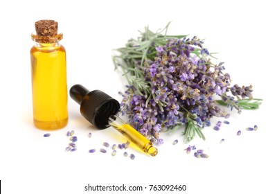 Bottle With Aroma Oil And Lavender Flowers Isolated On White Background