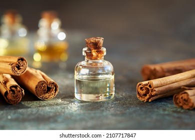 A bottle of aromatherapy essential oil with true cinnamon or Cinnamomum verum sticks