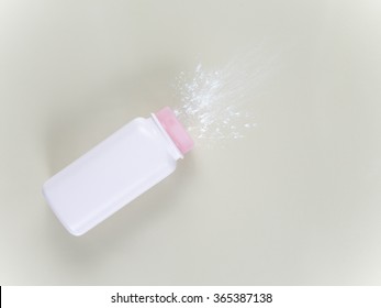 Bottle Of Baby Powder And Baby Powder Falling Spilled On The Floor