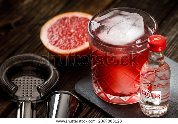 Bottle of Beefeater\
Gin. Red cocktail with ice and mint and grapefruit. MINSK, BELARUS\
- October 30, 2021.