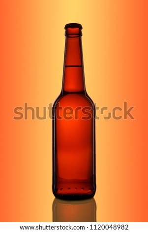 Bottle of beer or cider with clipping path isolated on orange gradient background.