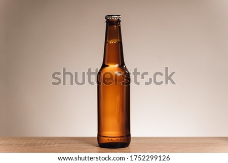 Bottle of beer isolated on white background on wood table