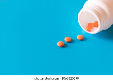 Bottle With Birth Control Pills . Isolated On Blue Background With Empty Text Space .