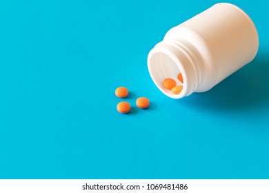 Bottle With Birth Control Pills . Isolated On Blue Background With Empty Text Space .