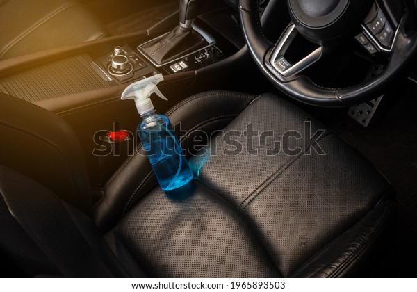 Bottle of blue sanitizer ethyl alcohol hand gel cleanser\
put in the car, prepare for protecting coronavirus, COVID-19\
concept 