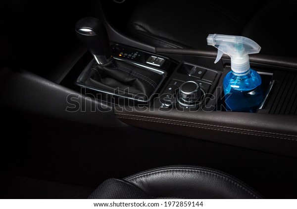 Bottle of blue sanitizer ethyl alcohol hand gel cleanser\
put in the car, prepare for protecting coronavirus, COVID-19\
concept 
