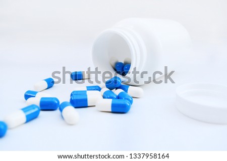 Bottle of blue and white pills. Medicine