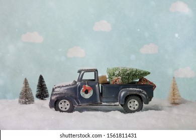 Bottle Brush Christmas Tree On A Toy Truck In A Winter Scene