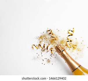 Bottle Of Champagne With Gold Glitter, Confetti And Space For Text On White Background, Top View. Hilarious Celebration