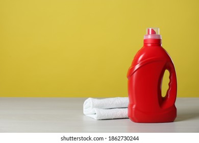 Bottle of cleaning product and microfiber cloth on light table. Space for text - Shutterstock ID 1862730244