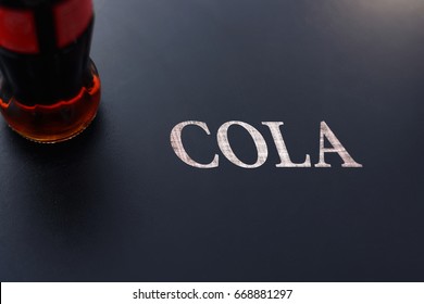 Bottle with cola on chalkboard with text Want - Powered by Shutterstock