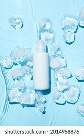 Bottle of cosmetic product and ice cubes in water on color background