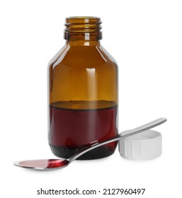 Bottle of cough syrup and spoon on white background