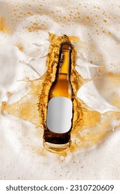 Bottle of delicious lager beer diving into foam of beer, splashes. Creative image for ad. Concept of alcohol drink, taste, vacation, holiday, brewery. Poster, flyer