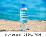 A bottle of drinking water on the sea beach
