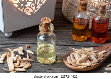 A bottle of essential oil with cedar wood chips