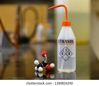 A Bottle Of Ethanol With Its Chemical Structure On A Laboratory Bench.