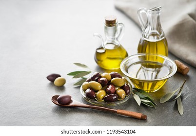 Bottle Of Extra Virgin Healthy Olive Oil With Fresh Olives Close Up