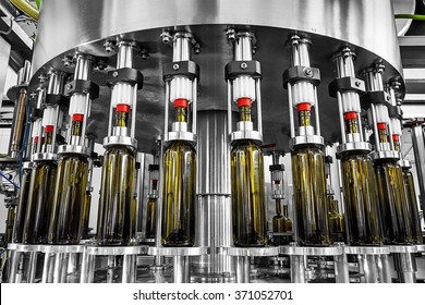 bottle filling,wine bottles filled with wine by an industrial machine in a wine factory