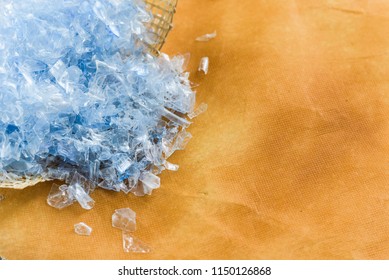 Bottle Flake,PET Bottle Flake,Plastic Bottle Crushed,Small Pieces Of Cut Blue Plastic Bottles On Yellow Background