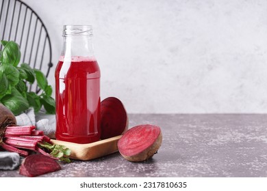 Bottle of fresh beetroot juice and vegetables on table - Powered by Shutterstock