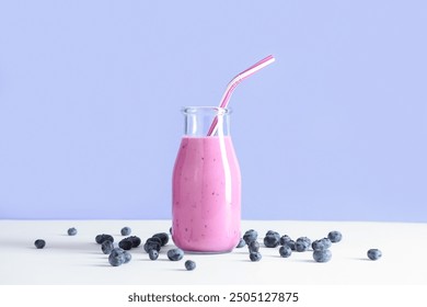 Bottle of fresh smoothie with blueberries on blue background - Powered by Shutterstock