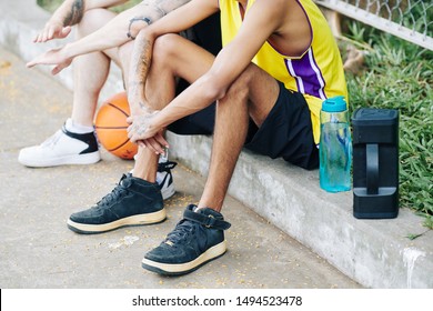 Bottle Of Fresh Water And Portable Speaker Next To Basketball Players Resting After Game