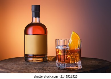 Bottle   glass and blended malt scotch whisky over blue orange gradient background
