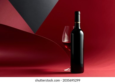 Bottle and glass of red wine. Copy space for your text.