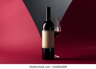 Bottle and glass of red wine. On a bottle old empty label with copy space for your text.