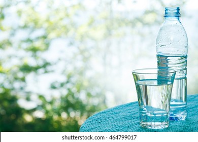 Bottle And Glass With Water On The Table