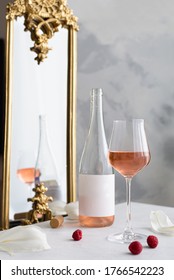 Bottle And Glasses Of Pink Rose Wine With Cork And Raspberries On Stone Table And Vintage Mirror Background. Side View. Valentines Day, Wedding Party Celebration. Wine Map, Menu. Copy Space