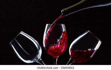 Bottle And Glasses With Red Wine On A Black Background