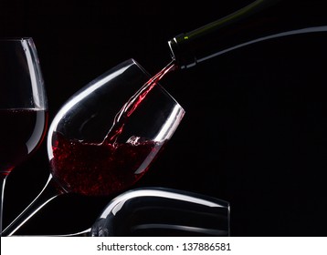 Bottle And Glasses With Red Wine On A Black Background