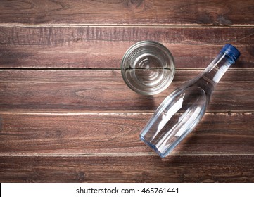 Bottle And Glasses Of Water On A Wooden Table,top View