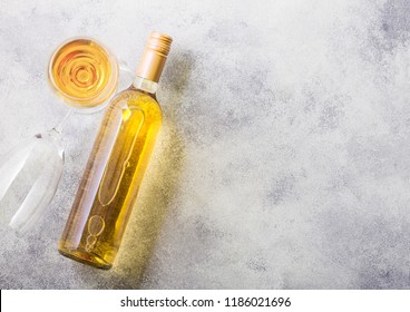 Bottle And Glasses Of White Wine Or Stone Kitchen Table Background. Top View. 