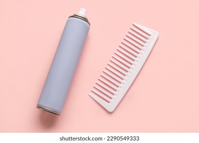 Bottle of hair spray and comb on color background - Powered by Shutterstock