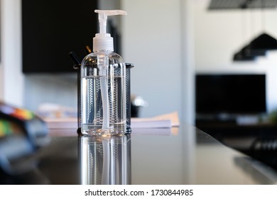 Bottle Of Hand Sanitizer On Office Reception Counter To Help Clean Hands