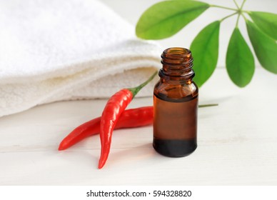 Bottle Of Holistic Extract Of Cayenne Pepper, Green Leaf,  Fresh Red Whole Plant Pods, White Terry Towel