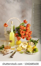 Bottle of homemade juice with ginger and lemon on light background. Vertical