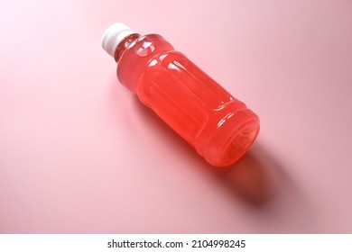 Bottle Of Homemade Raspberry Drink On The Pink Background