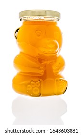 A bottle of honey in a bear bottle on an isolated background