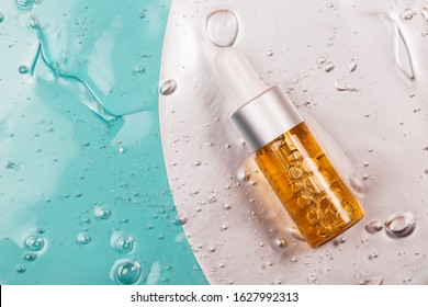 Bottle of hyaluronic acid on background with oxygen bubbles.