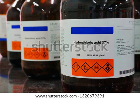 Bottle of Hydrochloric Acid, HCL with Properties information and its chemical hazard warning symbols. Corrosive, Inhalation,Toxic warning, Hazardous to the Environment.