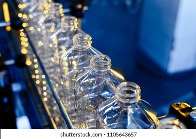 Bottle. Industrial production of plastic pet bottles. Factory line for manufacturing polyethylene bottles. Transparent food packaging.